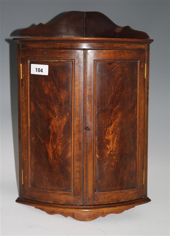 A small mahogany bowfront hanging cabinet, H.52cms